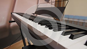 Digital piano black and white keys and empty music stand