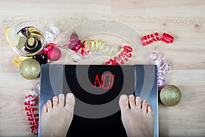 Digital scales with female feet on them and sign