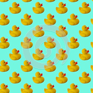 Digital seamless pattern of yellow rubber duck on green mint background