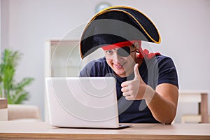 The digital security concept with pirate at computer