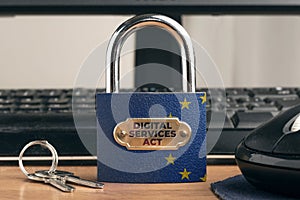 Digital services act DSA concept: lock with European Union Flag near to a computer