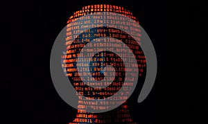 A digital silhouette of a head illuminated by glowing binary code, representing technology and data processing