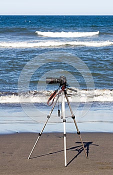 Digital SLR Camera On Tripod At The Ocean