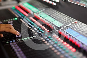 Digital sound mixing console with hand on faders