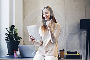 Digital specialist satisfied with her work showing thumb up while communicating online via messenger app. Girl making video call