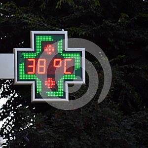 Street thermometer marking 38 degrees photo