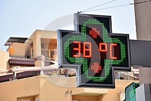 Street thermometer marking 38 degrees photo
