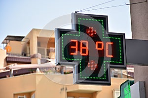 Street thermometer marking 38 degrees photo