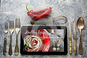 Digital table, healthy recipes, with whisk and antique silverwar