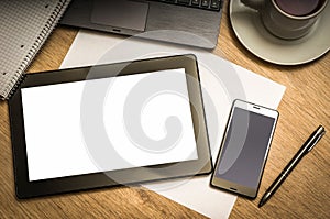 Digital tablet with blank screen on wooden table in office