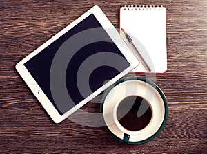 Digital tablet computer with note paper and cup of coffee