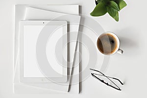 Digital tablet with empty blank mockup screen on white table top view