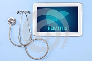 Digital tablet with hepatitis word and stethoscope