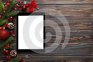 Digital tablet mock up with rustic Christmas decorations for app presentation top view with empty space for you design