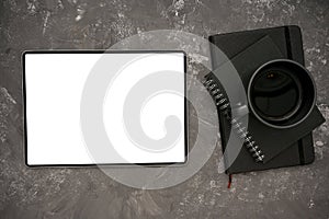 Digital tablet mockup, black coffee cup and black notebook on modern grey background