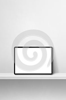 Digital tablet pc on white wall shelf. Vertical background banner