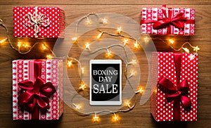 Digital tablet, presents and christmas lights, retro Boxing Day Sale concept