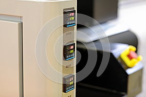 Digital temperature controllers on a control panel