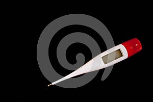 Digital thermometer on black background photo
