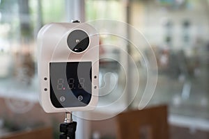 A digital thermometer device - Infection screening. photo