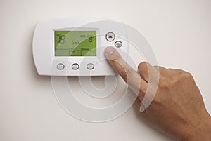 Digital Thermostat and male hand photo