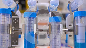 Digital tube rotisserie rotator for mixing biological blue liquid: close up