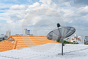 Digital TV Satellite receiver on the roof top with cloudy in the sky background