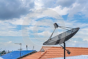 Digital TV Satellite receiver on the roof top with cloudy in the sky background