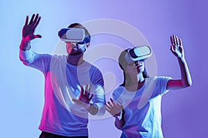 Digital world. Couple in virtual glasses make hands movements