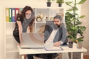 Digitalisation provides new business opportunities. Business professionals use laptop. Business couple in modern office