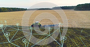 Digitalization of agriculture. Combine harvester working in the field aerial view. Futuristic agriculture concept