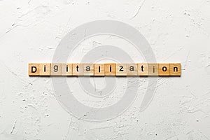 digitalization word written on wood block. digitalization text on cement table for your desing, concept