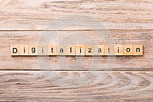 Digitalization word written on wood block. digitalization text on wooden table for your desing, concept