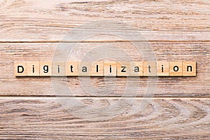 Digitalization word written on wood block. digitalization text on wooden table for your desing, concept photo