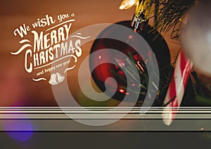 Digitally composite image of merry christmas and happy new year message against christmas bauble