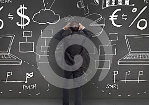 Digitally generated image of business professional looking at the blackboard