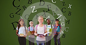 Digitally generated image of children holding books with letters flying against green background