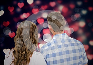 Digitally generated image of couple standing against bokeh background with hearts