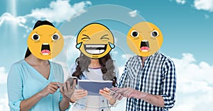 Digitally generated image of friends faces covered with emoji using digital tablet and smart phone a