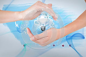 Digitally generated image of hand holding electric bulb