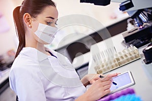 Digitizing her research and development. a young scientist using a digital tablet while working in a laboratory.