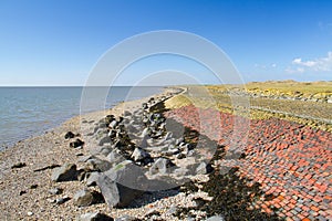 Dike with boulders and bricks