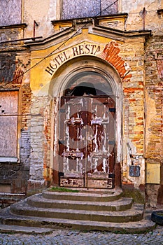 Dilapidated entrance to hotel restaurant in old building