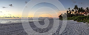 Dilapidated ruins of a pier on Port Royal Beach at sunset