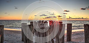 Dilapidated ruins of a pier on Port Royal Beach at sunset