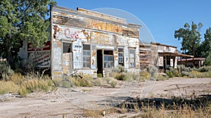 A dilapidated saloon with faded signage and broken windows reflects the scorching heat