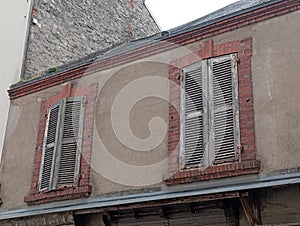 Dilapidated shutters on an old building in France