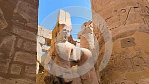 A dilapidated statue of the Pharaoh in front of the Karnak Temple in Egypt.