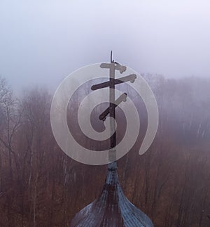 Dilapidated steeple on an Orthodox Ukrainian Church during a grey foggy morning