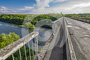 Dilapidated unsafe bridge over river. Abandoned building of emergency condition